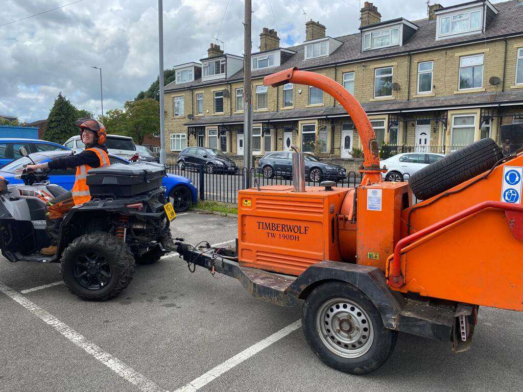 Tree surgeon towing a chipper through Bradford